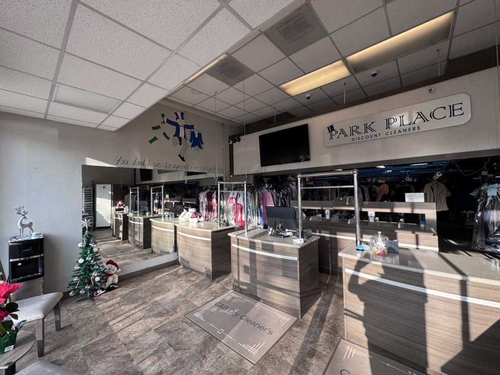The shop’s long front counter and garment conveyor, photographed while the old Park Place Discount Cleaners sign still hung on the wall