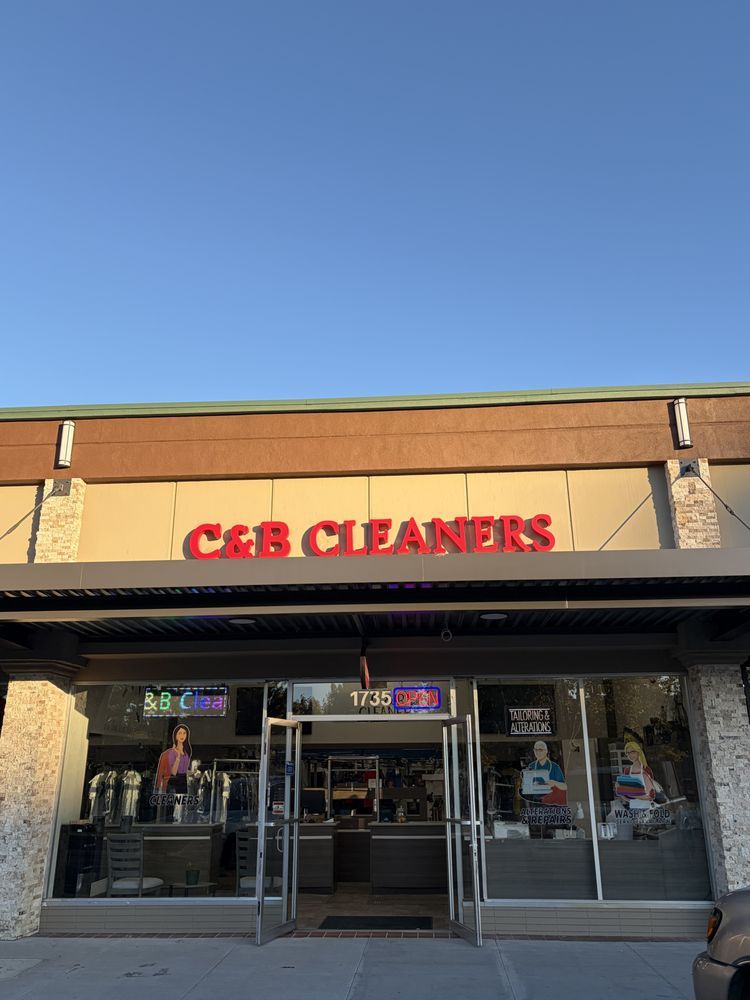 The C&B Cleaners storefront at 1735 Willow Pass Rd under a clear blue sky, red C&B CLEANERS letters above the glass doors
